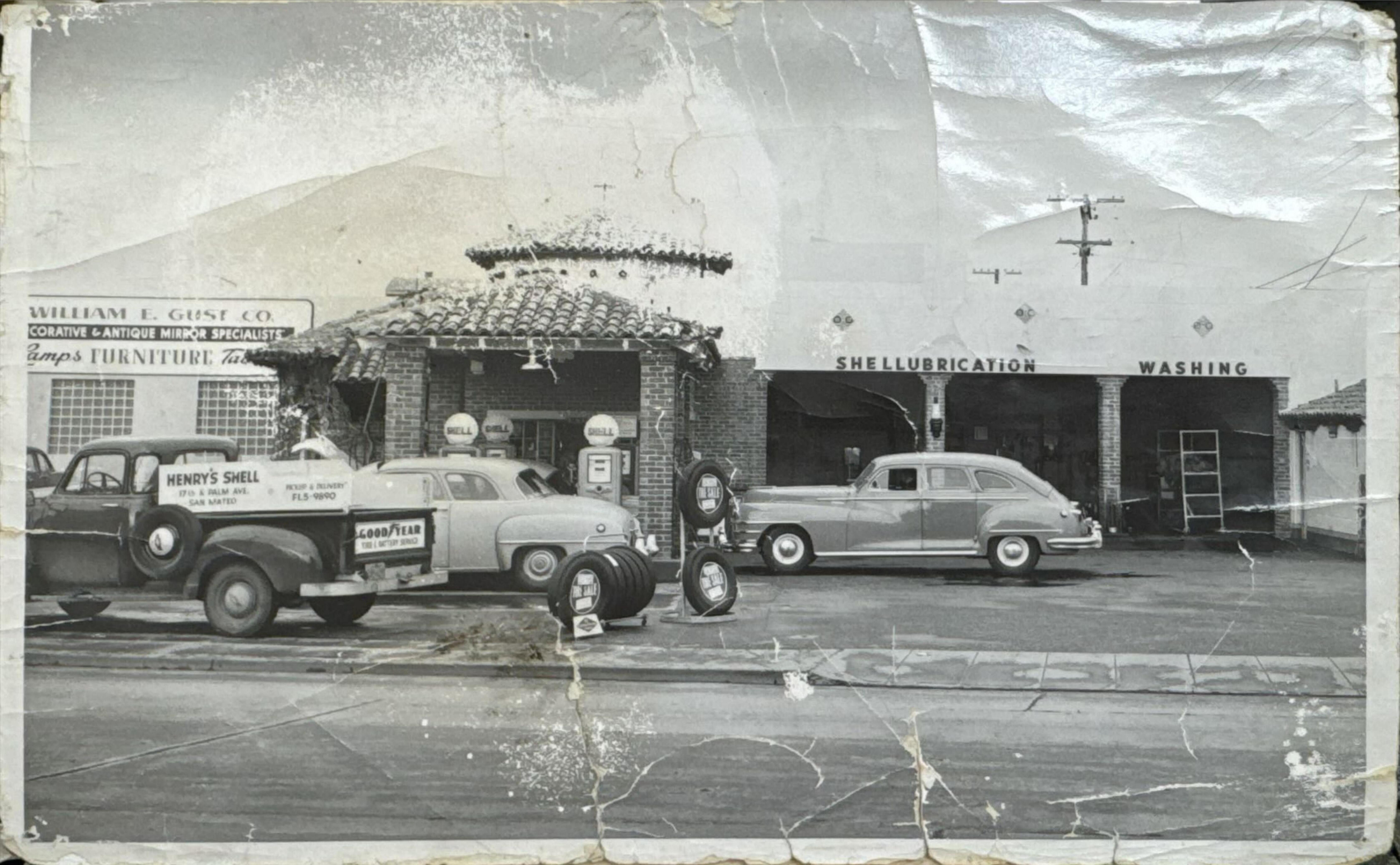 Black and white historical photo of Henry's Shell station, the original building at 1641 Palm Avenue