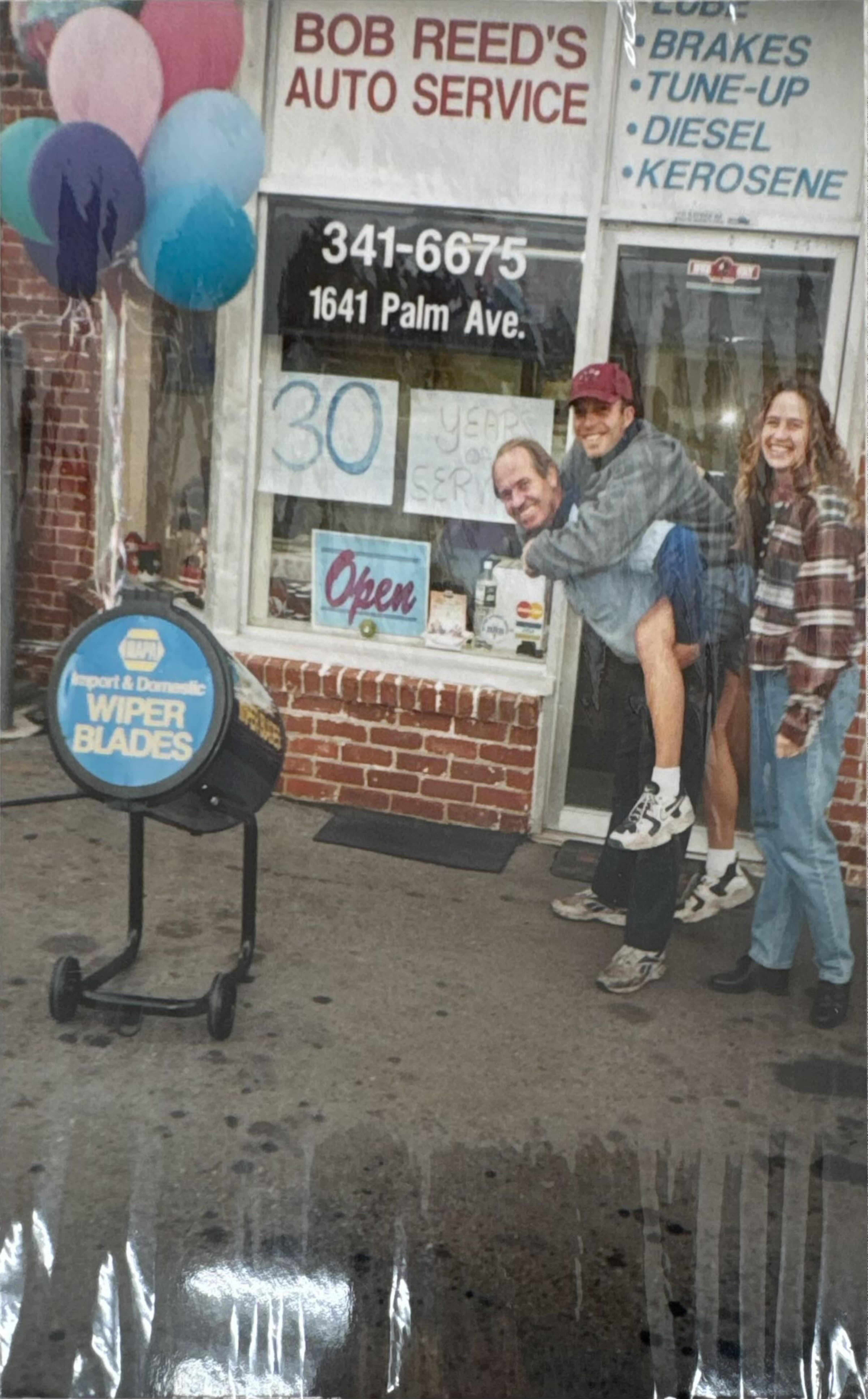 The Reed family celebrating 30 years of service outside the station, with balloons